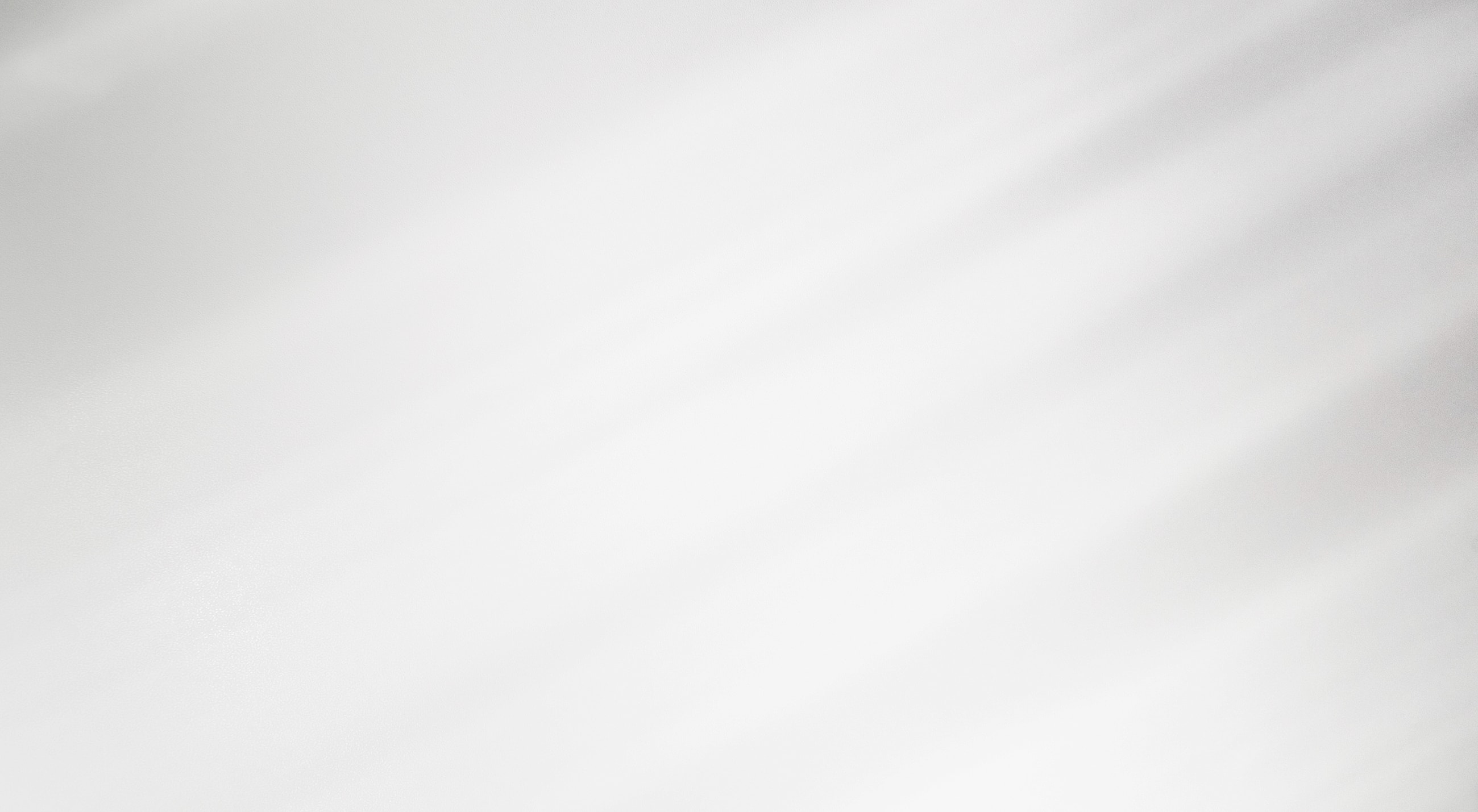 Abstract white texture with soft light gradients.