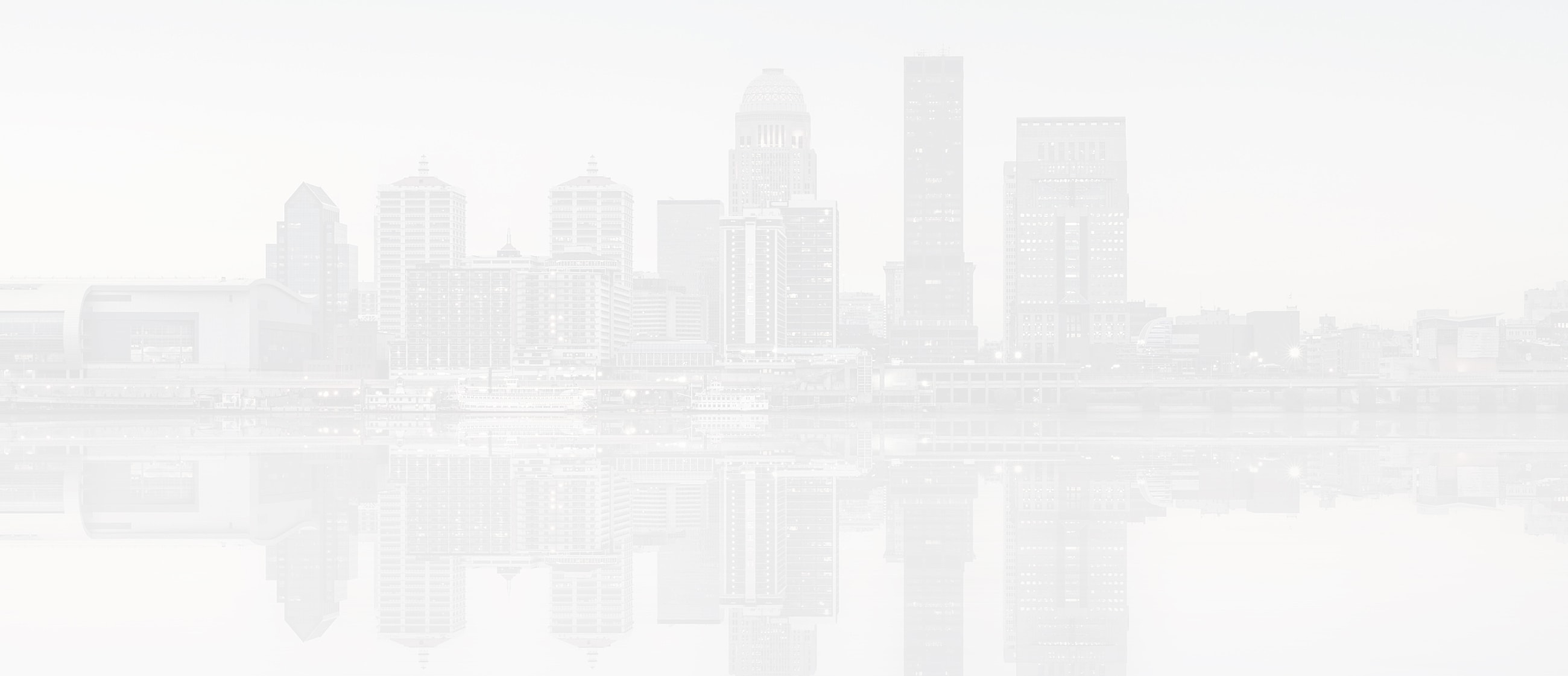 City skyline with reflection on calm water.