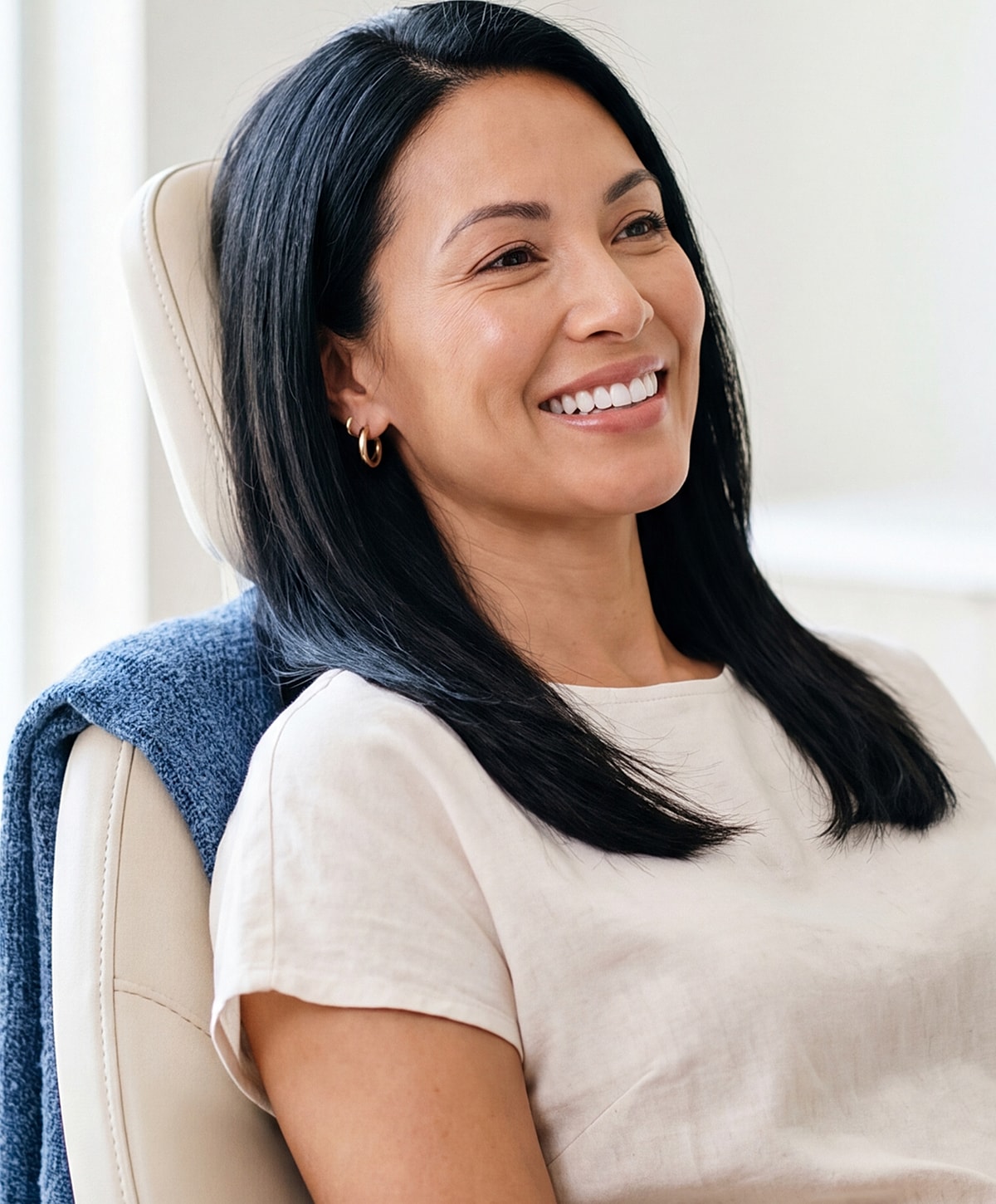 Woman smiling in a dental chair.
