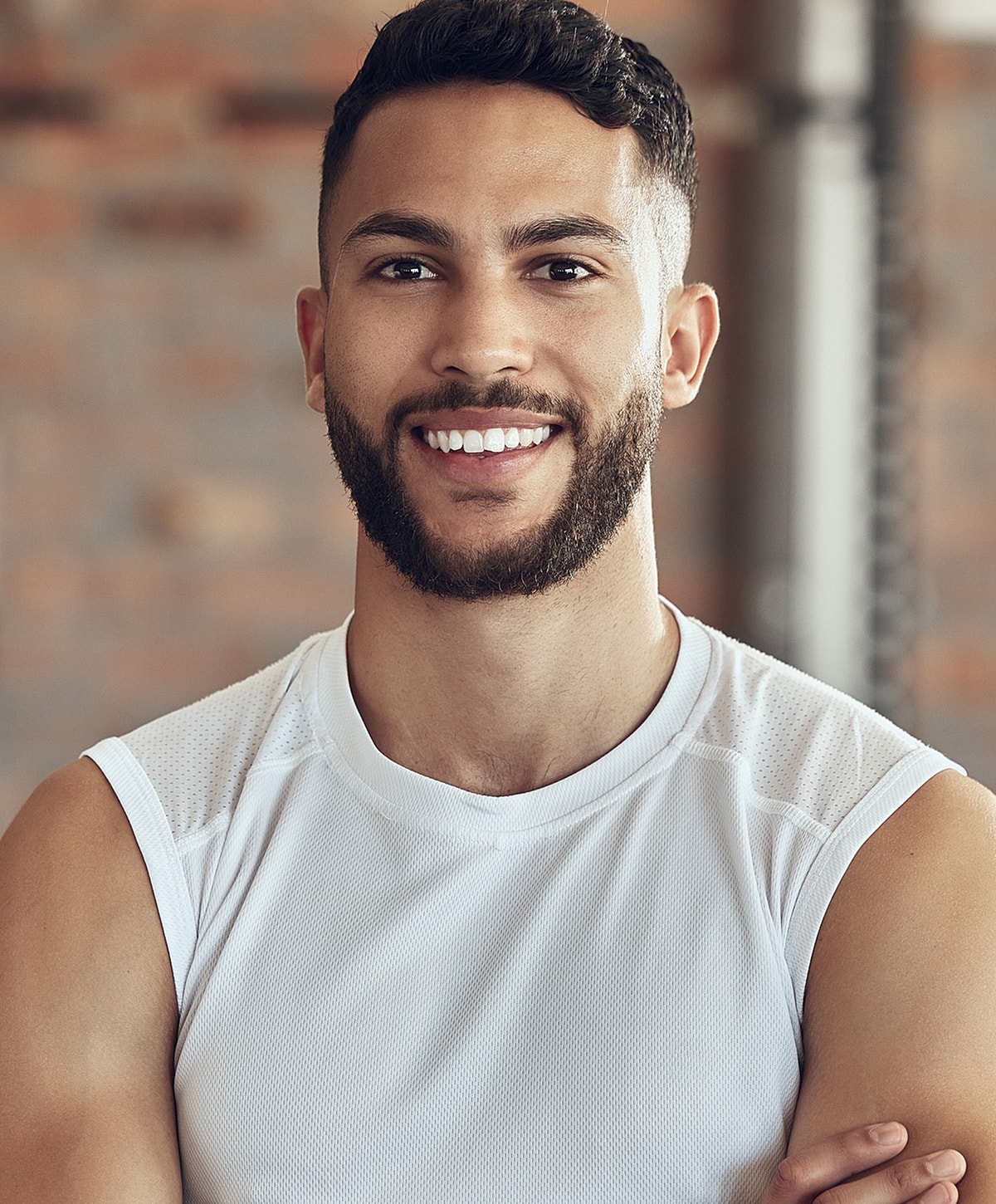 Smiling man in athletic attire, close-up portrait.