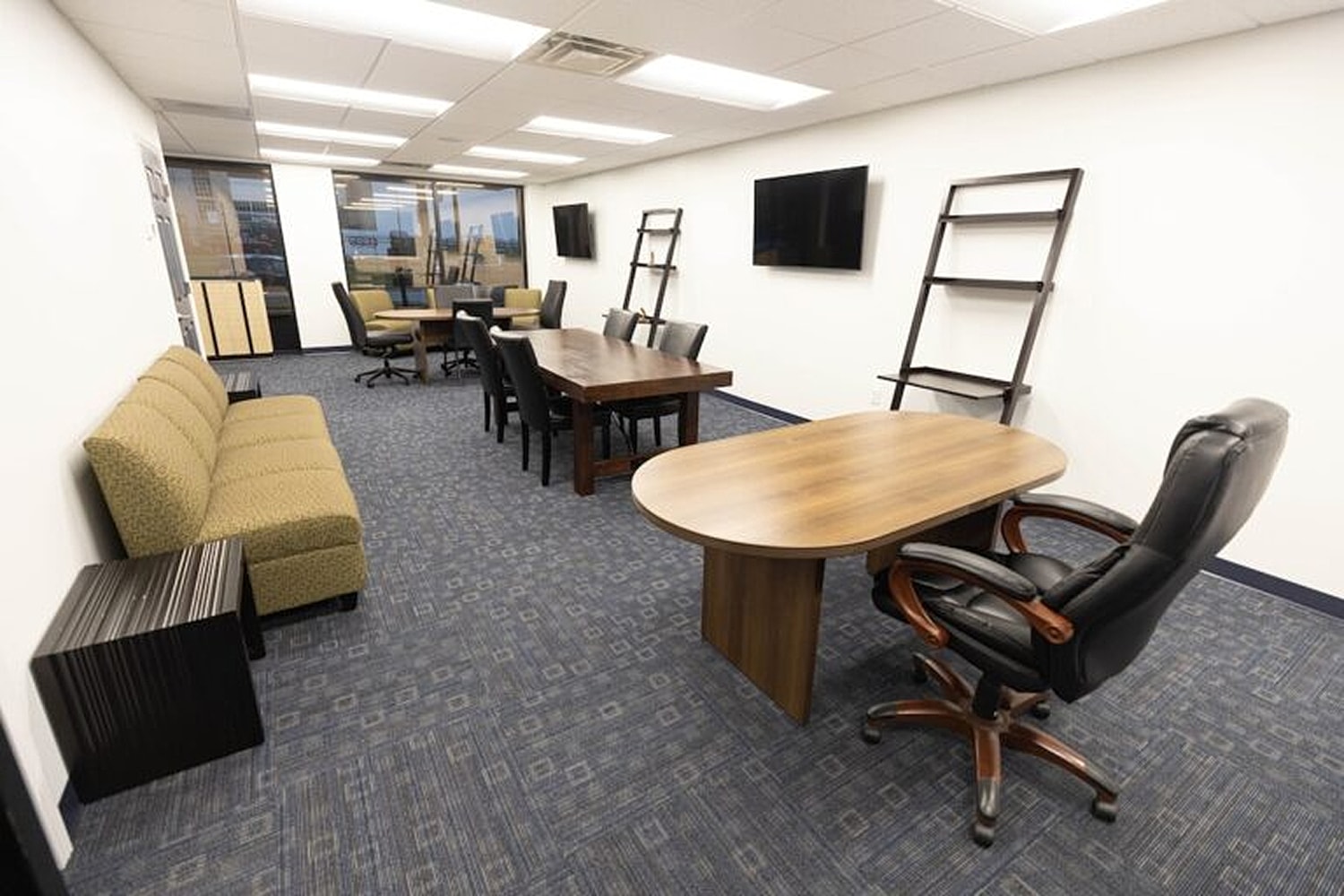 Modern office space with seating and meeting tables.