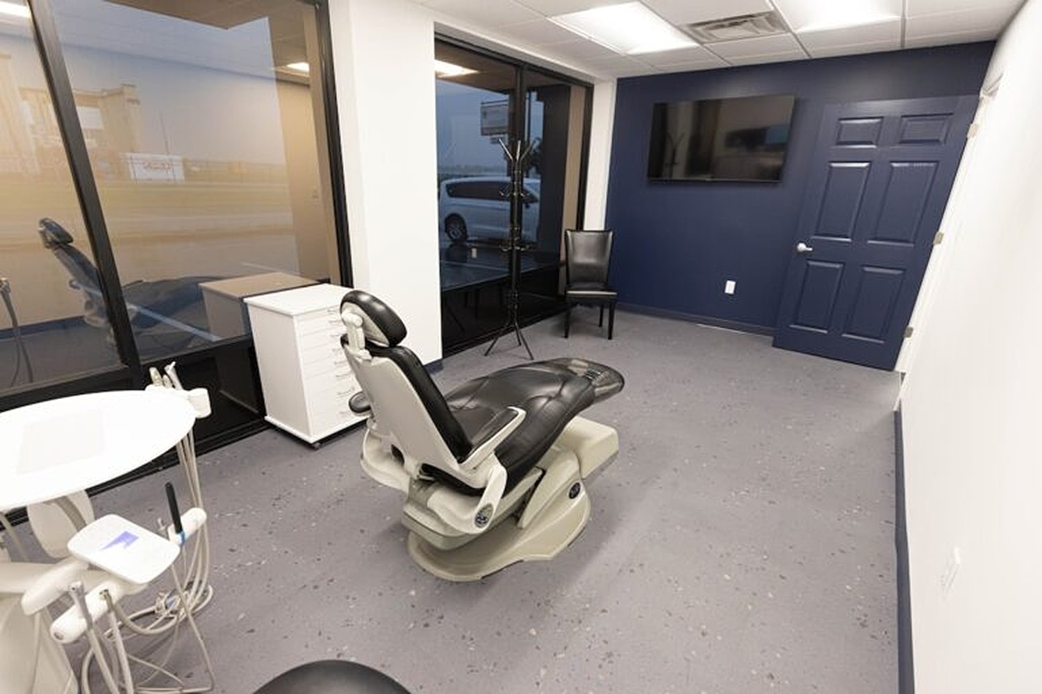 Modern dental office with chair and equipment.