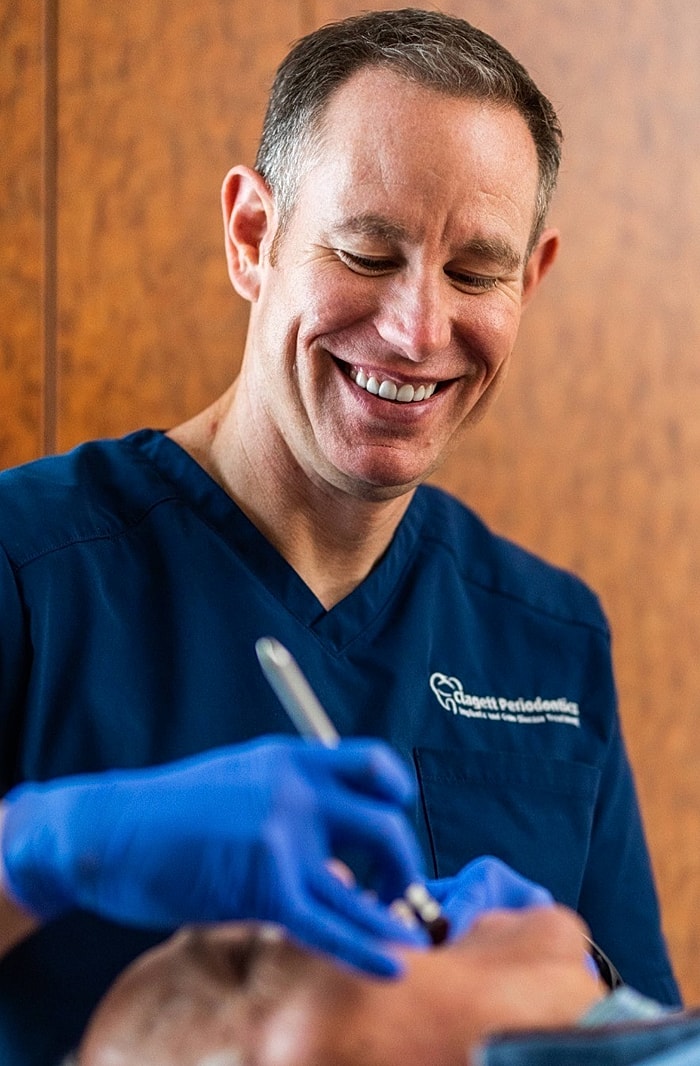 Dentist smiling during a patient's procedure.