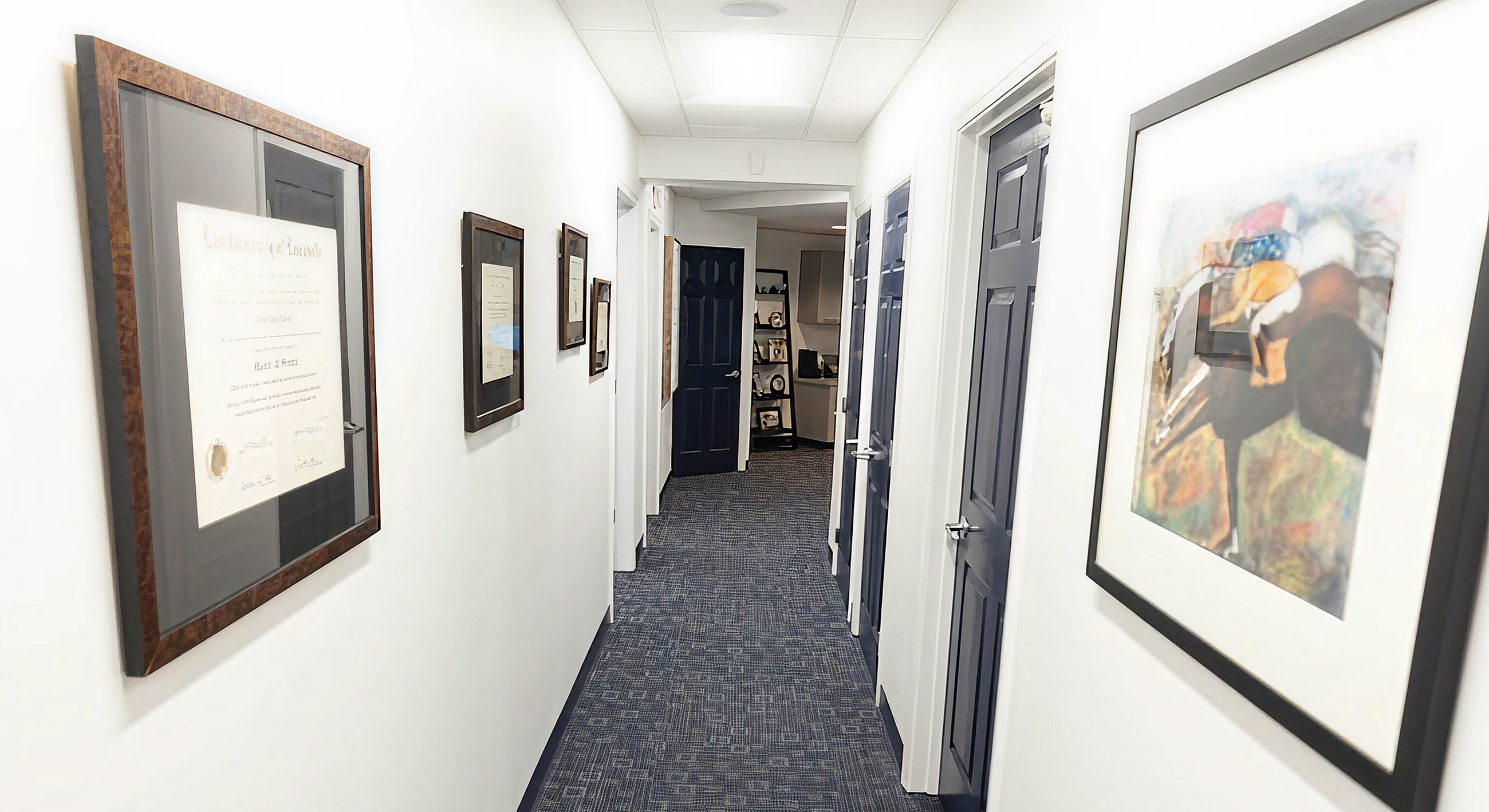 Hallway with framed documents and artwork.