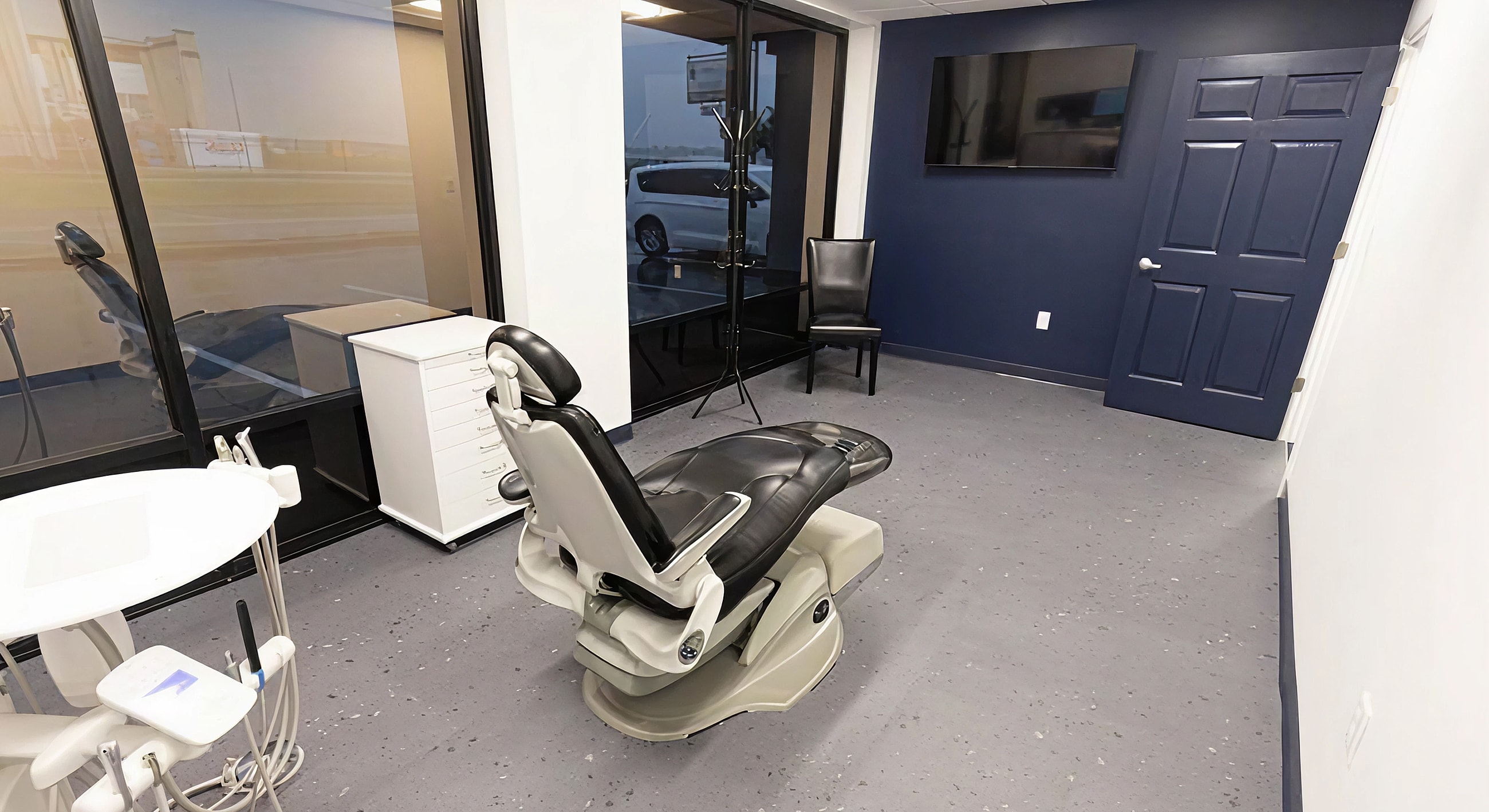 Modern dental office interior with treatment chair.